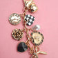 BOW CHECKER HEART FLOWER BAG CHARM | 80K049: Gold